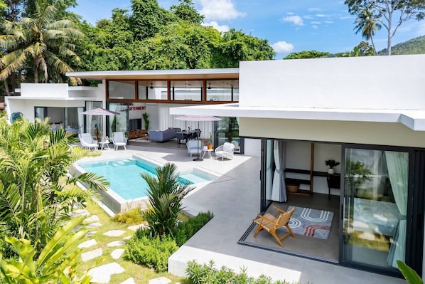 Aerial view of Buddha Garden Villa showcasing the lush tropical garden, sparkling pool, and expansive sun terrace.