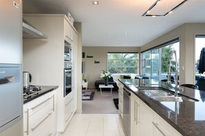 Open plan kitchen, granite bench with seating for four, all modern amenities