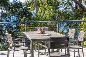 Outdoor dining among the gum trees and sounds of waves crashing below.