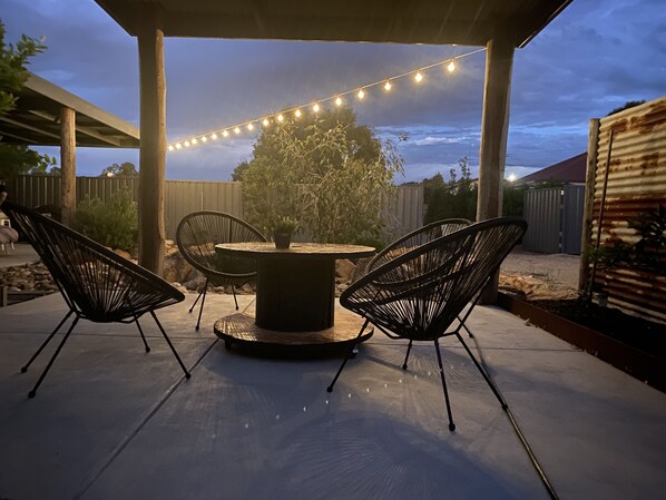 Undercover seating area in back yard. 