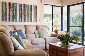Get cosy in the second living area with reclining sofas and a wood-burning fireplace, ideal for quiet evenings with a glass of local wine and a good book.