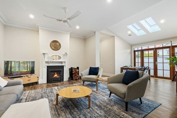 Living & Dining room with a wood burner to relax by in the cooler months. Nothing better!